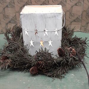 Distressed Lantern of stars with a primitive wreath of greenery.